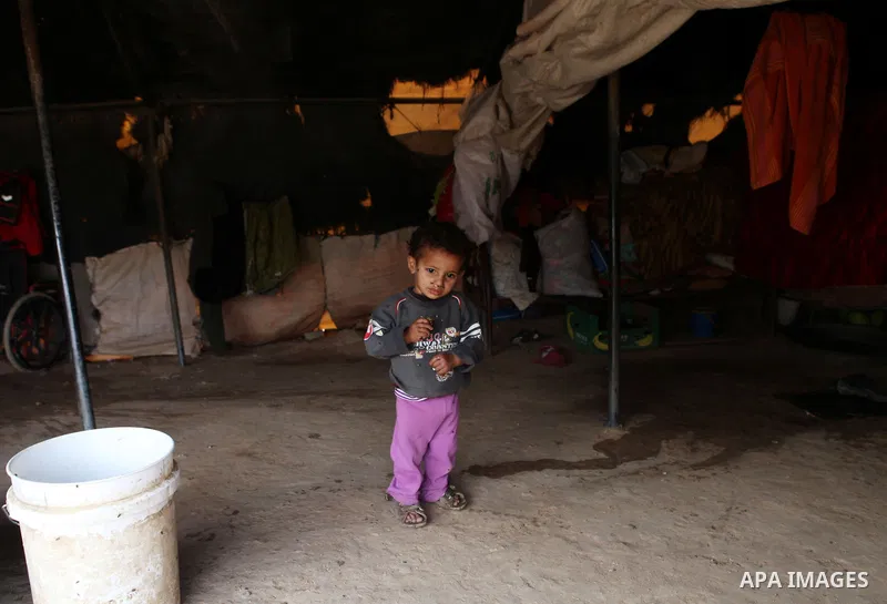 A Bedouin boy plays at his family's dwellings in the Jordan Valley near West Bank city of Jericho on November 29, 2014. Photo by Shadi Hatem