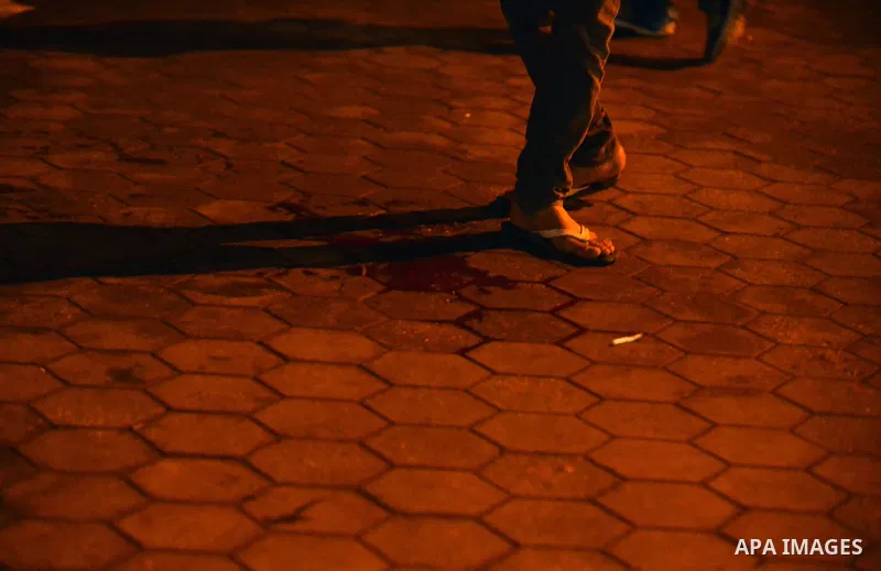 An Egyptian man stands near a blood stain following disperse an anti-Mubarak protest Egyptian riot police at Abdel Moneim Riad, a main transportation hub for taxis and buses, after hearing the verdict of former Egyptian...