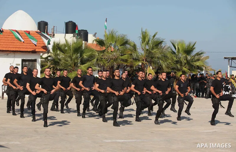 Palestinian members of officer display their skills during a graduation ceremony in Gaza city on November 30, 2014. Photo by Ashraf Amra