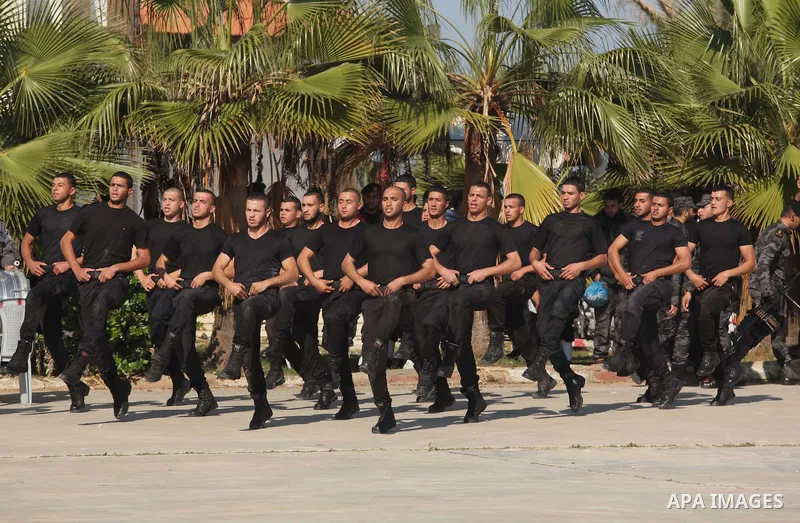 Palestinian members of officer display their skills during a graduation ceremony in Gaza city on November 30, 2014. Photo by Ashraf Amra