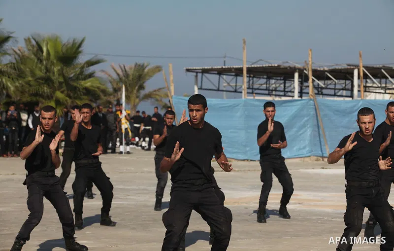 Palestinian members of officer display their skills during a graduation ceremony in Gaza city on November 30, 2014. Photo by Ashraf Amra
