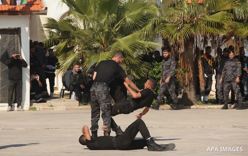 Palestinian members of officer display their skills during a graduation ceremony in Gaza city on November 30, 2014. Photo by Ashraf Amra