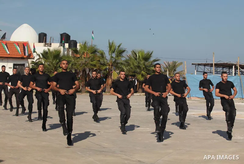 Palestinian members of officer display their skills during a graduation ceremony in Gaza city on November 30, 2014. Photo by Ashraf Amra