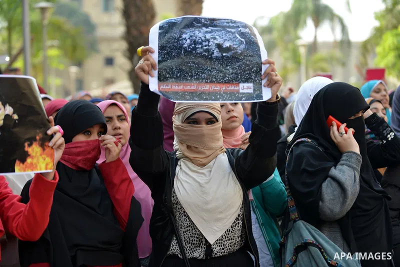 Egyptian student who support Muslim Brotherhood and ousted president Mohammed Mursi, take part in a protest one day after a court dismissed murder charges against former president Hosni Mubarak at Cairo University, Egypt...