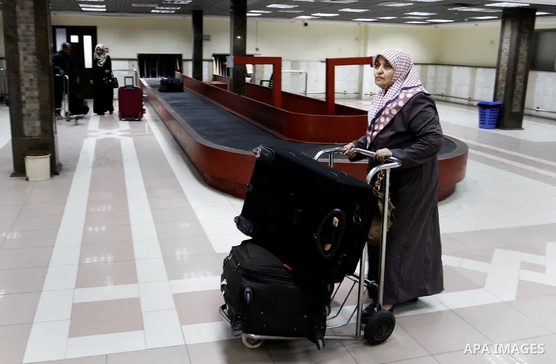 A Palestinian woman crosses into Gaza through the Rafah border crossing between Egypt and southern Gaza Strip on November 30, 2014. Egyptian authorities reopened this week the Rafah crossing with Gaza for two days this w...