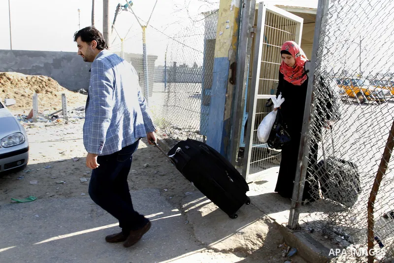Palestinians cross into Gaza through the Rafah border crossing between Egypt and southern Gaza Strip on November 30, 2014. Egyptian authorities reopened this week the Rafah crossing with Gaza for two days this week to al...