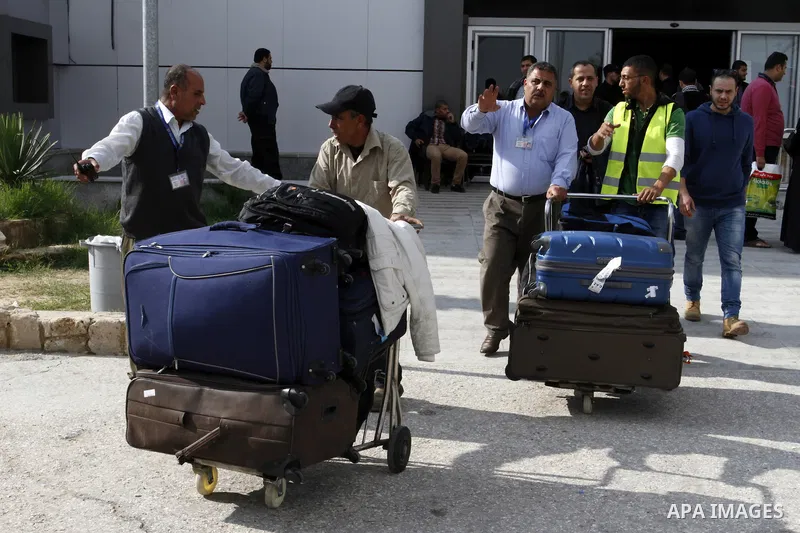 Palestinians cross into Gaza through the Rafah border crossing between Egypt and southern Gaza Strip on November 30, 2014. Egyptian authorities reopened this week the Rafah crossing with Gaza for two days this week to al...