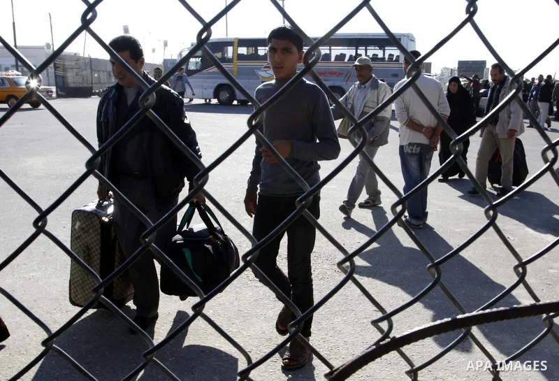 Palestinians cross into Gaza through the Rafah border crossing between Egypt and southern Gaza Strip on November 30, 2014. Egyptian authorities reopened this week the Rafah crossing with Gaza for two days this week to al...