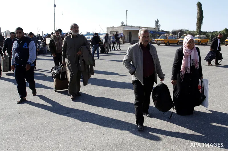 Palestinians cross into Gaza through the Rafah border crossing between Egypt and southern Gaza Strip on November 30, 2014. Egyptian authorities reopened this week the Rafah crossing with Gaza for two days this week to al...