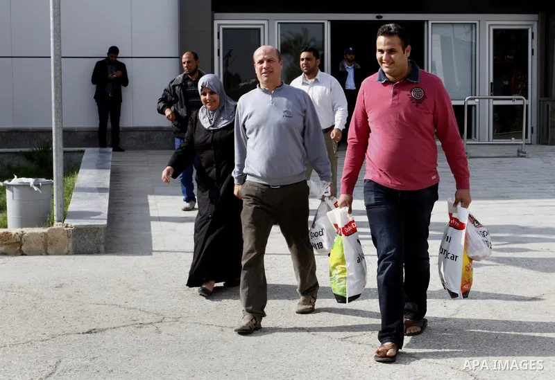 Palestinians cross into Gaza through the Rafah border crossing between Egypt and southern Gaza Strip on November 30, 2014. Egyptian authorities reopened this week the Rafah crossing with Gaza for two days this week to al...