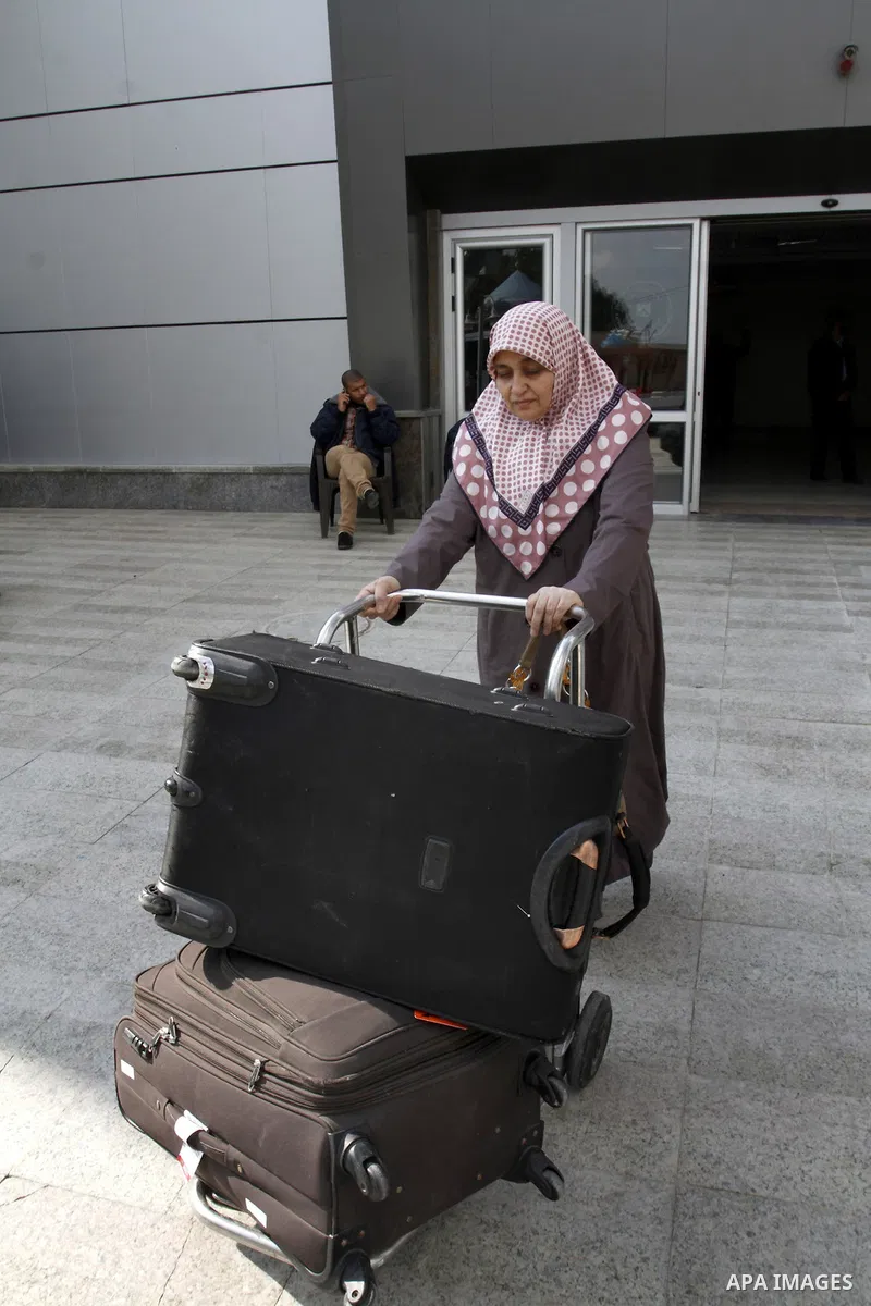 A Palestinian woman crosses into Gaza through the Rafah border crossing between Egypt and southern Gaza Strip on November 30, 2014. Egyptian authorities reopened this week the Rafah crossing with Gaza for two days this w...