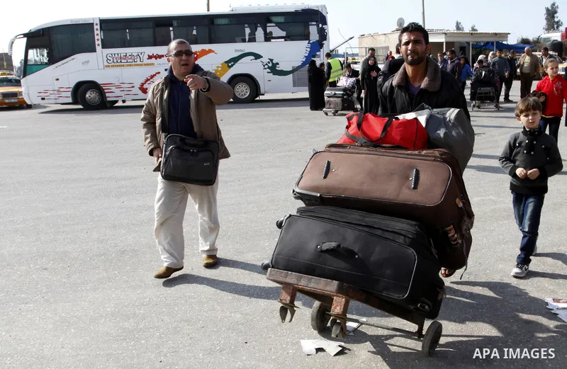 Palestinians cross into Gaza through the Rafah border crossing between Egypt and southern Gaza Strip on November 30, 2014. Egyptian authorities reopened this week the Rafah crossing with Gaza for two days this week to al...