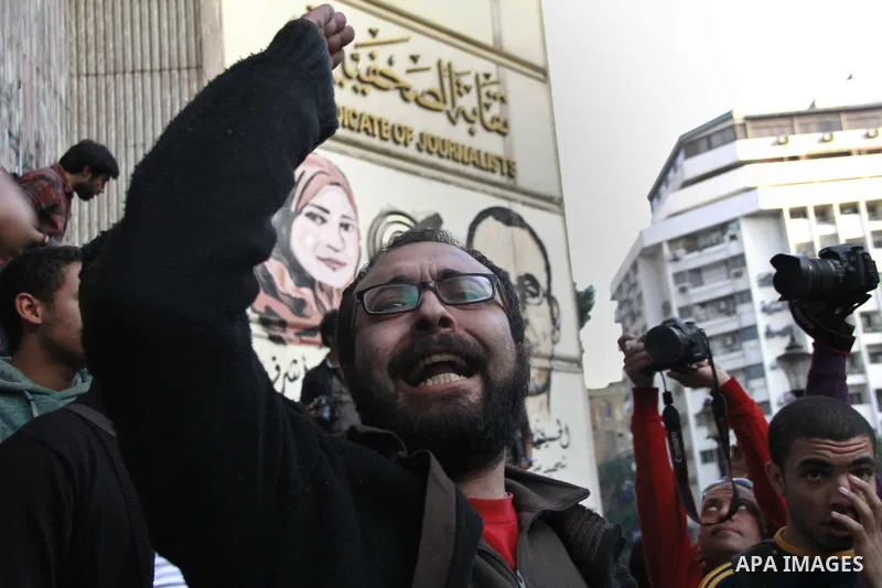 Egyptians chant slogans during a protest denouncing toppled President Hosni Mubarak in front of the press syndicate in Cairo, Egypt, Tuesday, Dec. 2, 2014. A judge on Saturday dismissed the case against Mubarak and acqui...