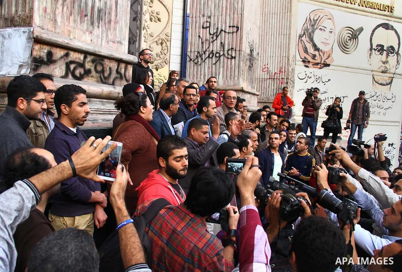 Egyptians chant slogans during a protest denouncing toppled President Hosni Mubarak in front of the press syndicate in Cairo, Egypt, Tuesday, Dec. 2, 2014. A judge on Saturday dismissed the case against Mubarak and acqui...