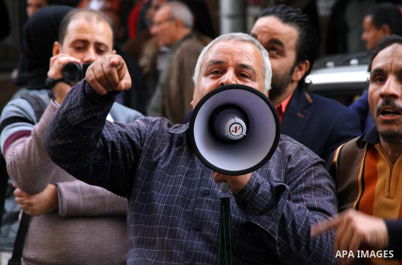 Egyptians chant slogans during a protest denouncing toppled President Hosni Mubarak in front of the press syndicate in Cairo, Egypt, Tuesday, Dec. 2, 2014. A judge on Saturday dismissed the case against Mubarak and acqui...