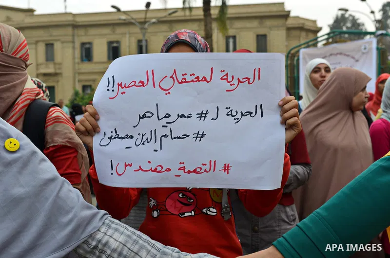 Egyptian students who are members in Students Against the Coup group (SAC), take part in a demonstration against the Cairo Criminal Court's decision to drop charges against former president Hosni Mubarak, at Cairo Univer...