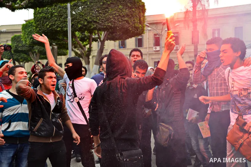 Egyptian students who are members in Students Against the Coup group (SAC), take part in a demonstration against the Cairo Criminal Court's decision to drop charges against former president Hosni Mubarak, at Cairo Univer...