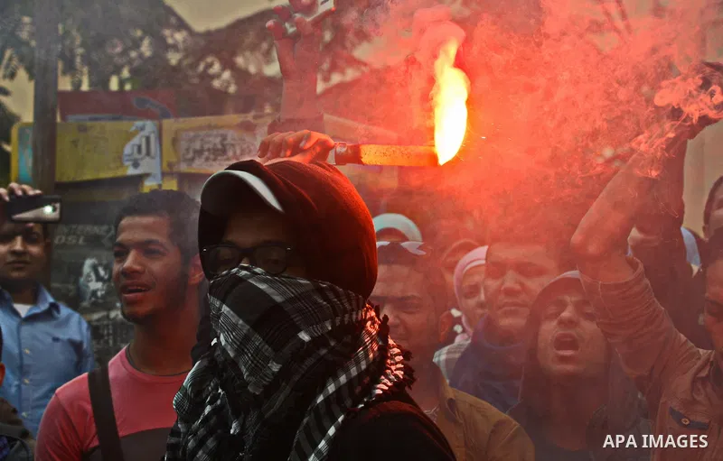 Egyptian students who are members in Students Against the Coup group (SAC), take part in a demonstration against the Cairo Criminal Court's decision to drop charges against former president Hosni Mubarak, at Cairo Univer...