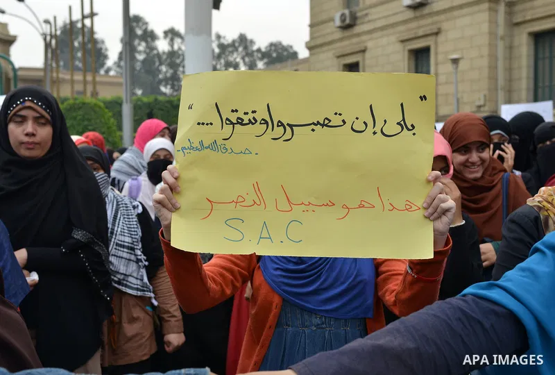 Egyptian students who are members in Students Against the Coup group (SAC), take part in a demonstration against the Cairo Criminal Court's decision to drop charges against former president Hosni Mubarak, at Cairo Univer...