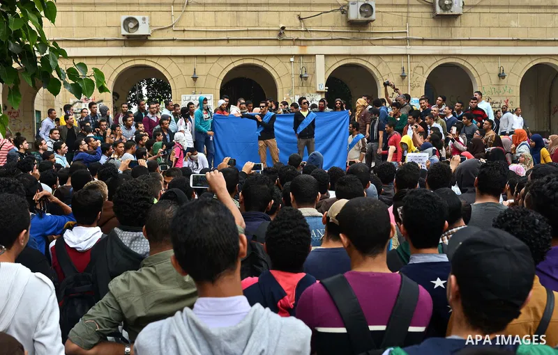 Egyptian students who are members in Students Against the Coup group (SAC), take part in a demonstration against the Cairo Criminal Court's decision to drop charges against former president Hosni Mubarak, at Cairo Univer...