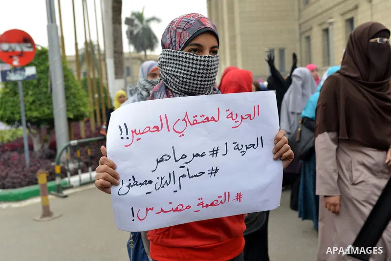 Egyptian students who are members in Students Against the Coup group (SAC), take part in a demonstration against the Cairo Criminal Court's decision to drop charges against former president Hosni Mubarak, at Cairo Univer...