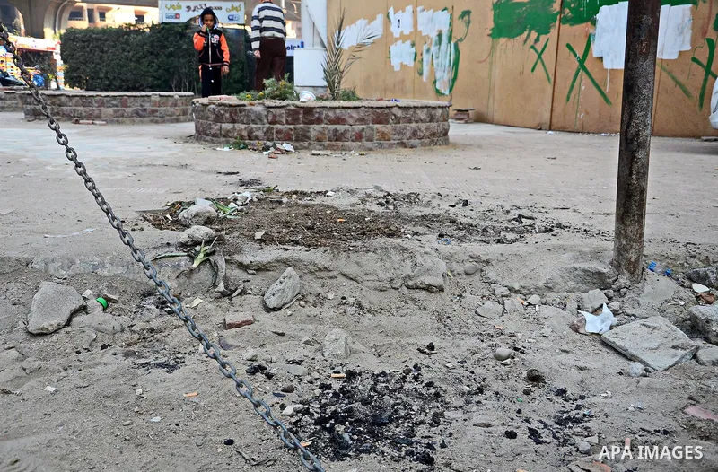An Egyptian boy stands watch at the scene after defused a bomb by civil protection forces in al-Haram street, near Cairo, December 5, 2014. Photo by Amr Sayed