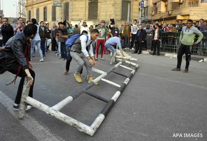 Egyptian protesters shout slogans on Abdel Moneim Riad Square in the capital Cairo on December 5, 2014, during a demonstration against a court's decision to drop a murder charge against ousted president Hosni Mubarak. A...