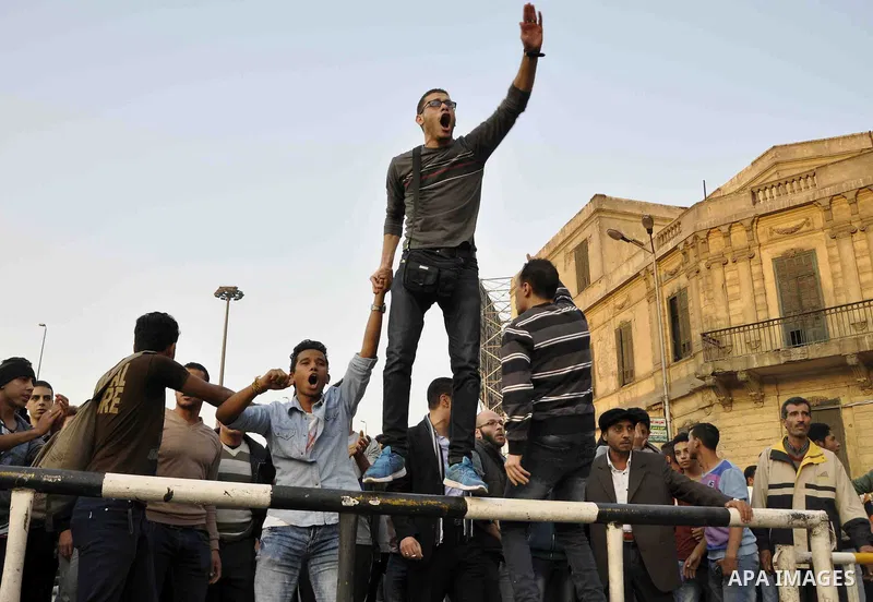 Egyptian protesters shout slogans on Abdel Moneim Riad Square in the capital Cairo on December 5, 2014, during a demonstration against a court's decision to drop a murder charge against ousted president Hosni Mubarak. A...