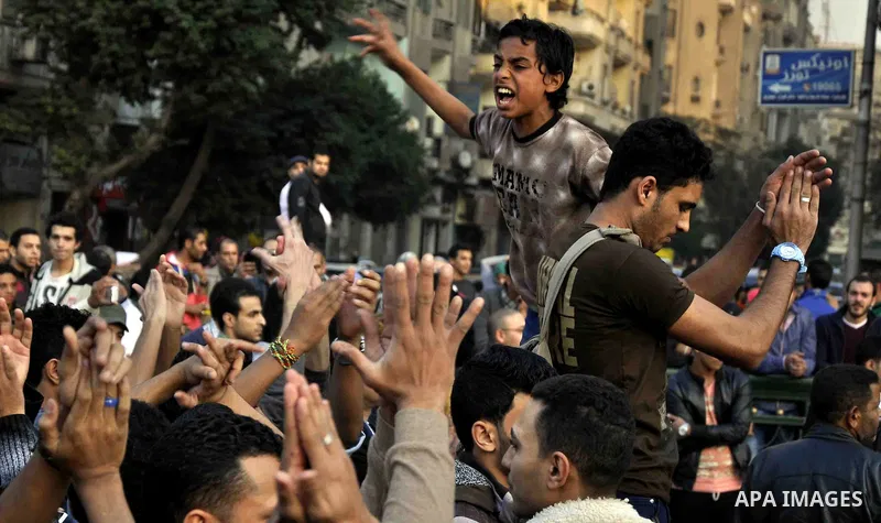 Egyptian protesters shout slogans on Abdel Moneim Riad Square in the capital Cairo on December 5, 2014, during a demonstration against a court's decision to drop a murder charge against ousted president Hosni Mubarak. A...