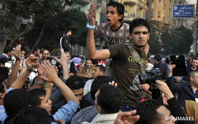 Egyptian protesters shout slogans on Abdel Moneim Riad Square in the capital Cairo on December 5, 2014, during a demonstration against a court's decision to drop a murder charge against ousted president Hosni Mubarak. A...