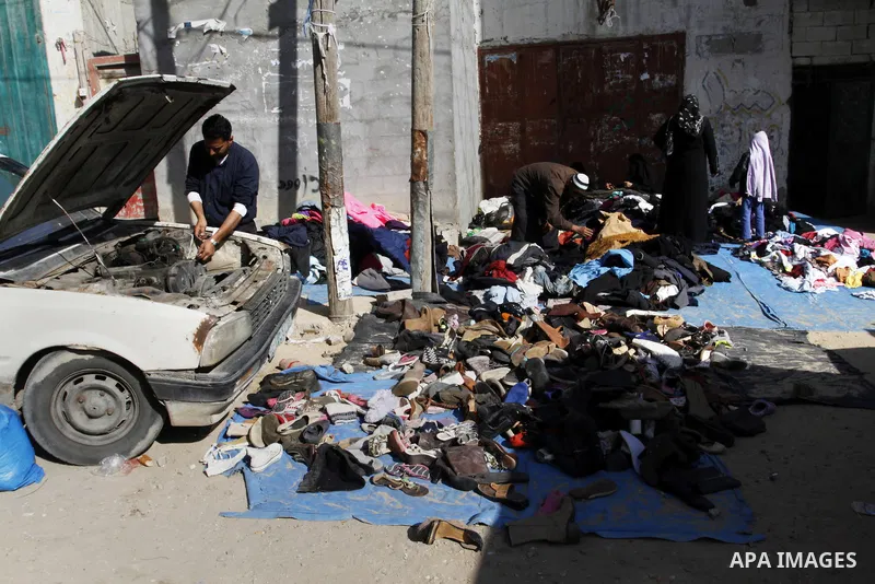 Palestinians looks at second hand clothes at a market in Rafah in the southern Gaza strip, December 06, 2014. Due to the current economic situation in Gaza Strip, many of the Palestinians resort to meet their needs of us...