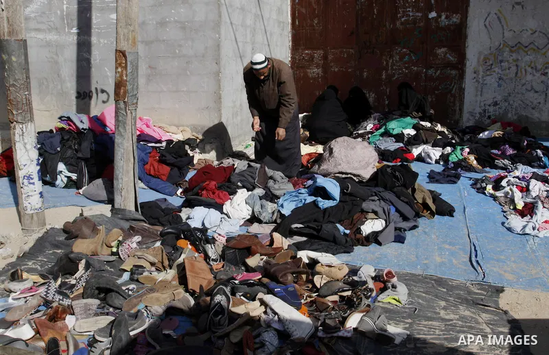 Palestinians looks at second hand clothes at a market in Rafah in the southern Gaza strip, December 06, 2014. Due to the current economic situation in Gaza Strip, many of the Palestinians resort to meet their needs of us...