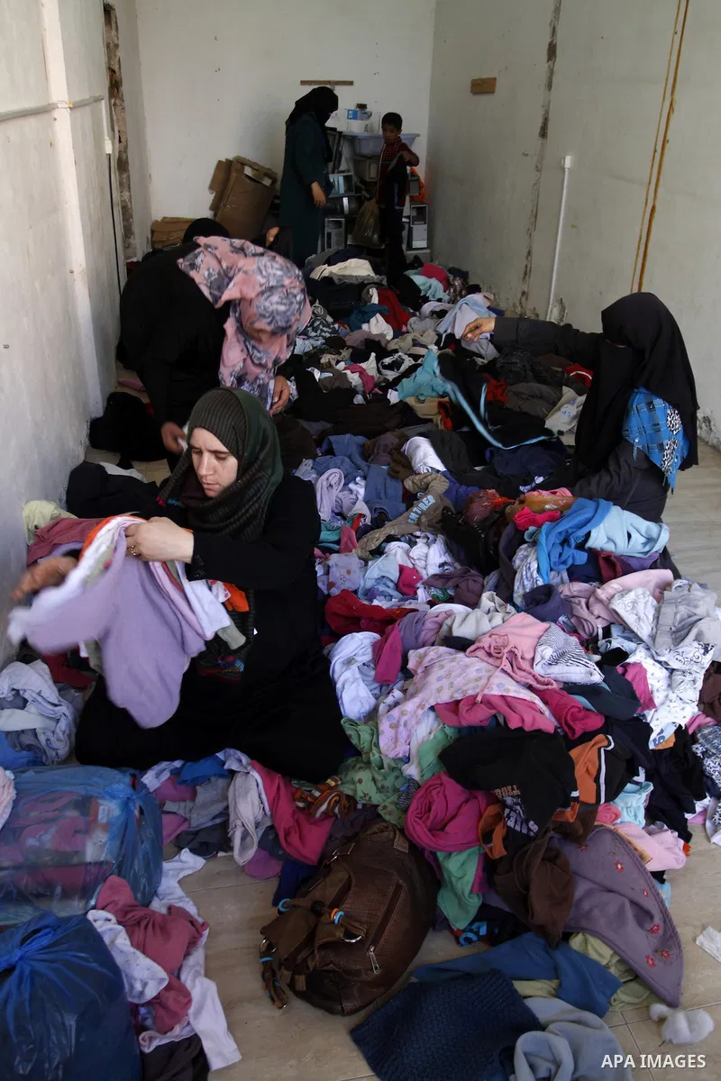 Palestinians looks at second hand clothes at a market in Rafah in the southern Gaza strip, December 06, 2014. Due to the current economic situation in Gaza Strip, many of the Palestinians resort to meet their needs of us...