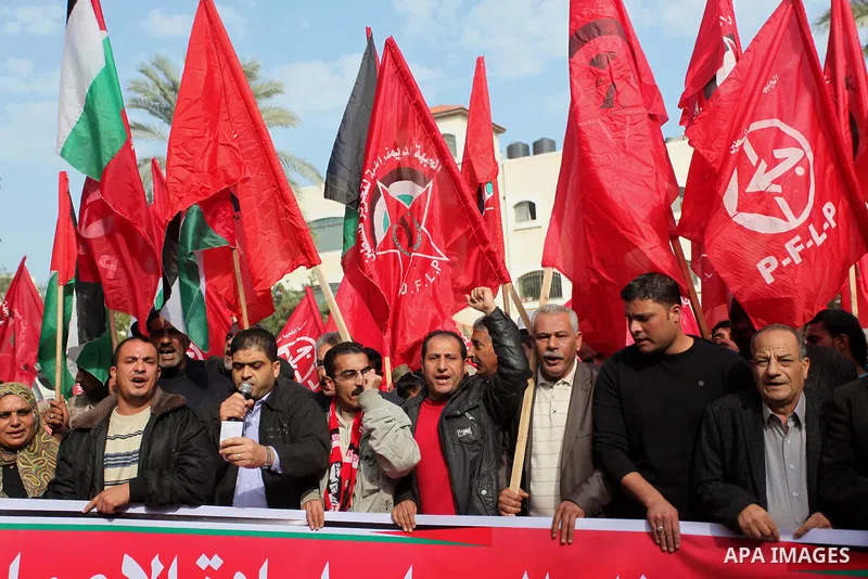 Palestinian supporters of the Popular Front for the Liberation of Palestine (PFLP) gather during a protest against the delay in acquiring building material in front of the United Nations office in Gaza city on December 7...