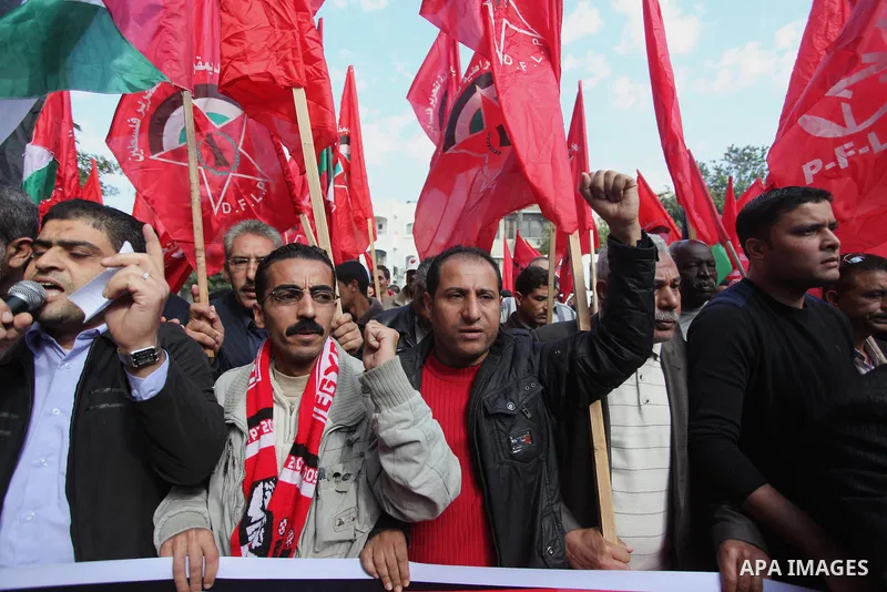 Palestinian supporters of the Popular Front for the Liberation of Palestine (PFLP) gather during a protest against the delay in acquiring building material in front of the United Nations office in Gaza city on December 7...