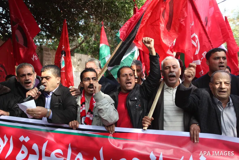 Palestinian supporters of the Popular Front for the Liberation of Palestine (PFLP) gather during a protest against the delay in acquiring building material in front of the United Nations office in Gaza city on December 7...