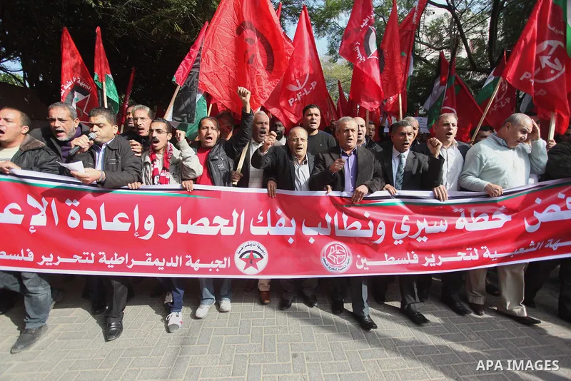 Palestinian supporters of the Popular Front for the Liberation of Palestine (PFLP) gather during a protest against the delay in acquiring building material in front of the United Nations office in Gaza city on December 7...