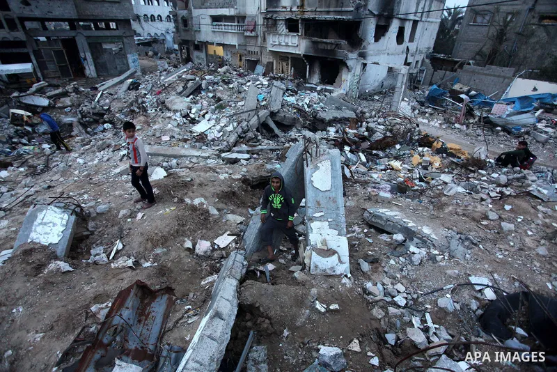 Palestinian children play on the rubbles of a house, which was destroyed during the recent Israeli offensive on Gaza Strip, in Shijaiyah neighborhood, east Gaza City, December 8, 2014. According to housing minister Mufee...