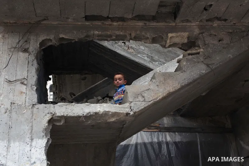 A Palestinian boy plays on the rubbles of a house, which was destroyed during the recent Israeli offensive on Gaza Strip, in Shijaiyah neighborhood, east Gaza City, December 8, 2014. According to housing minister Mufeed...