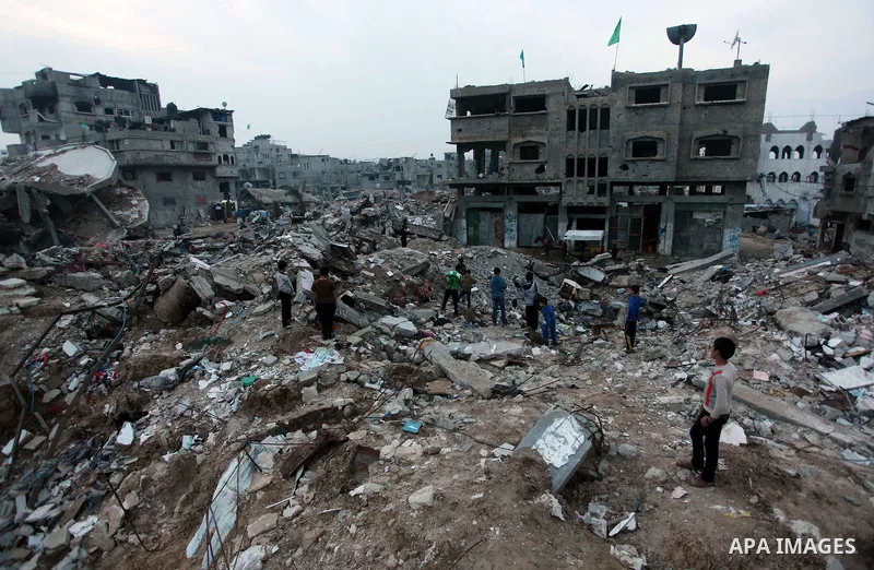 Palestinian children play on the rubbles of a house, which was destroyed during the recent Israeli offensive on Gaza Strip, in Shijaiyah neighborhood, east Gaza City, December 8, 2014. According to housing minister Mufee...