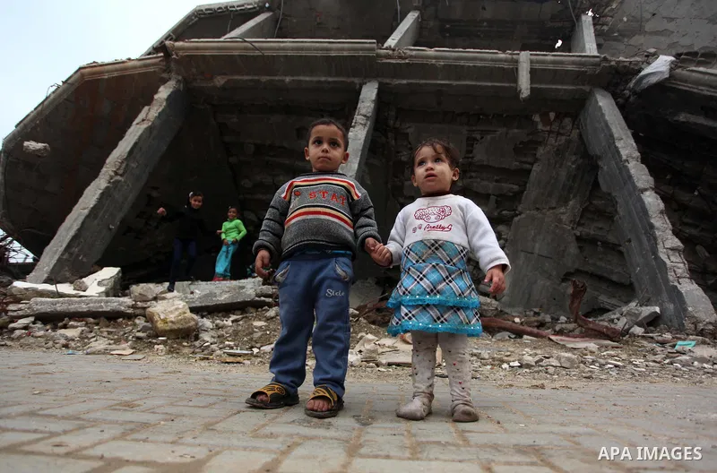 Palestinian children play on the rubbles of a house, which was destroyed during the recent Israeli offensive on Gaza Strip, in Shijaiyah neighborhood, east Gaza City, December 8, 2014. According to housing minister Mufee...