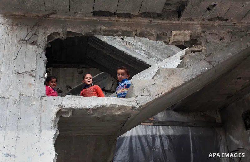 Palestinian children play on the rubbles of a house, which was destroyed during the recent Israeli offensive on Gaza Strip, in Shijaiyah neighborhood, east Gaza City, December 8, 2014. According to housing minister Mufee...