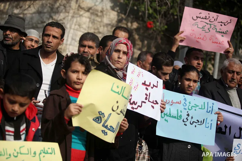 Palestinian refugees from Syrian, Yemen, Libya, take part in a protest to demand their rights, in front of the headquarters of the Council of Ministers in Gaza city December 9, 2014. Photo by Ashraf Amra