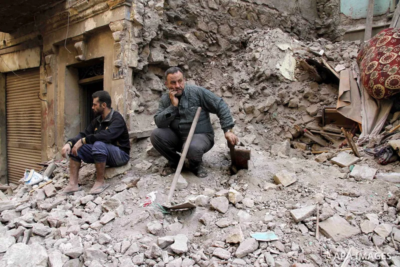 Egyptians and rescue workers inspect the site of a collapsed two-storey building in the Cairo district of Torgoman, December 9, 2014. The Ministry of Health and Population of Egypt injuring two people in the collapse of...