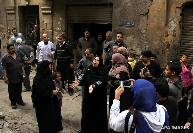 Egyptians and rescue workers inspect the site of a collapsed two-storey building in the Cairo district of Torgoman, December 9, 2014. The Ministry of Health and Population of Egypt injuring two people in the collapse of...