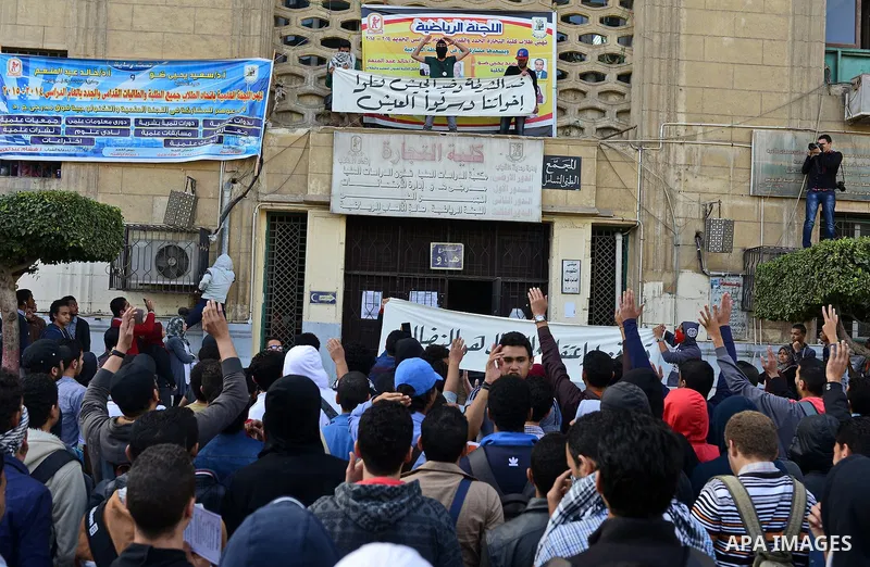 Egyptian students, who are members of Students Against the Coup group (SAC), take part in a demonstration against the military rule, at Cairo University on December 9, 2014. Photo by Amr Sayed