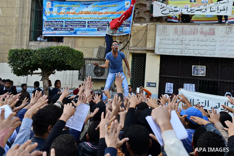 Egyptian students, who are members of Students Against the Coup group (SAC), take part in a demonstration against the military rule, at Cairo University on December 9, 2014. Photo by Amr Sayed