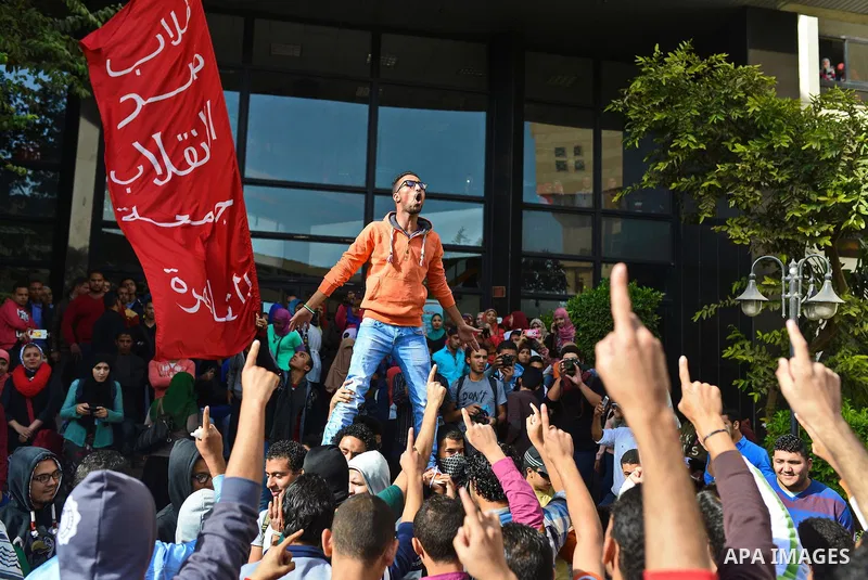 Egyptian students, who are members of Students Against the Coup group (SAC), take part in a demonstration against the military rule, at Cairo University on December 9, 2014. Photo by Amr Sayed