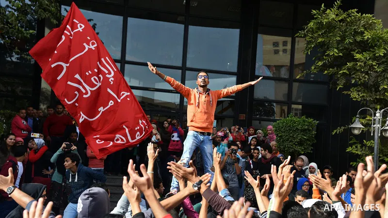Egyptian students, who are members of Students Against the Coup group (SAC), take part in a demonstration against the military rule, at Cairo University on December 9, 2014. Photo by Amr Sayed