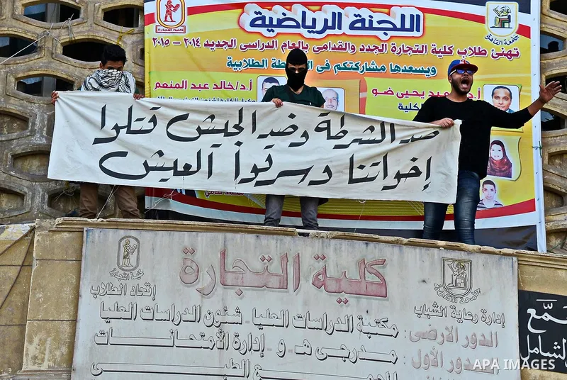 Egyptian students, who are members of Students Against the Coup group (SAC), take part in a demonstration against the military rule, at Cairo University on December 9, 2014. Photo by Amr Sayed